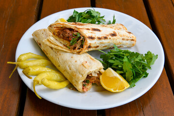 Lavash doner kebab ( zurna doner durum )  or shawarma sliced in plate isolated. 