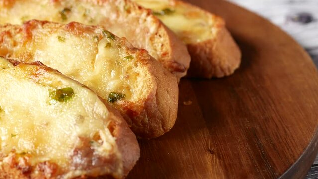  top view of slice of garlic bread on black background 