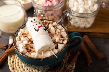Hot chocolate mug with melted marshmallow snowman.Sweet treat for kids funny marshmallow snowman. Christmas winter holiday decoration. New Year card.Winter hot drink.