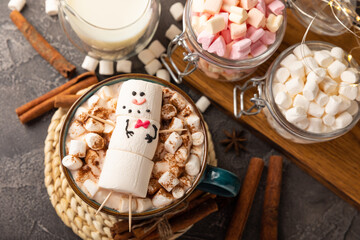 Hot chocolate mug with melted marshmallow snowman.Sweet treat for kids funny marshmallow snowman. Christmas winter holiday decoration. New Year card.Winter hot drink.