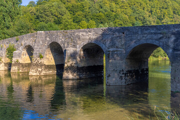Fototapeta na wymiar The old stone bridge on the Dobra River, Croatia