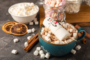 Hot chocolate mug with melted marshmallow snowman.Sweet treat for kids funny marshmallow snowman. Christmas winter holiday decoration. New Year card.Winter hot drink.