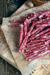 thin dried meat sausages with spices , close up