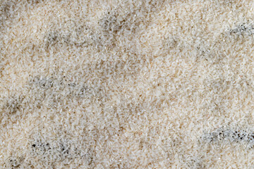 a pile of scattered white rice on the kitchen table