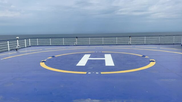Blue marked helipad for helicopter landing on ferry out in the sea