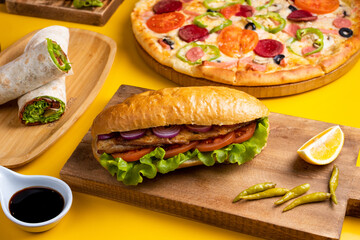 Fish doner kebab, pizza and durum kebab top view