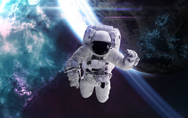 Fototapeta na wymiar Astronaut in outer space against backdrop of distant inhabited planet. Science fiction. Elements of this image furnished by NASA