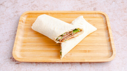 Beef durum kebab on wooden tray. Beef lavash doner kebab.