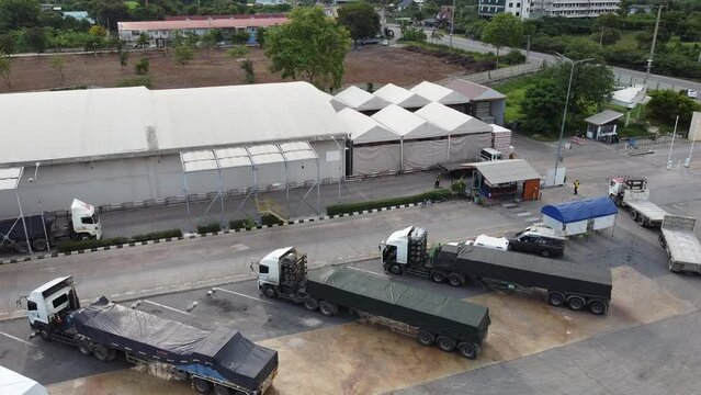 4K over Semi Trucks in the Warehouse during transportation on the leading commodity. Photo of logistic from Aerial View.