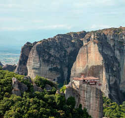 Fototapeta na wymiar Meteora Greece. Holy Monastery of Rousanos Saint Barbara building on top of rock