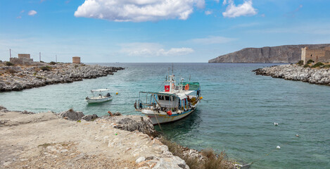 Greece. Gerolimenas village, Mani Laconia, Peloponnese. Fishing boat in calm sea.