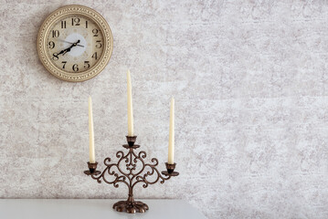 Background in Provence style with wall clock and candles in a candlestick. Copy space.