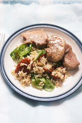 Pork loin with rice, spinach and sun dried tomatoes