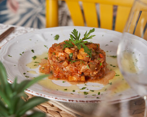 Delicious fish tartar on a white plate. Italian food concept. Ready to eat at a restaurant
