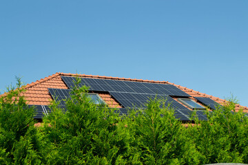 House roof with photovoltaic modules. Historic farm house with modern solar panels on roof and wall High quality photo