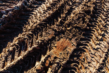 Car tracks on a dirty road. Texture of brown soil in the countryside. flat frame