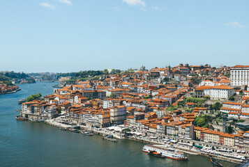 Fototapeta na wymiar View of Duoro bay of Oporto city from top with boats navigating 