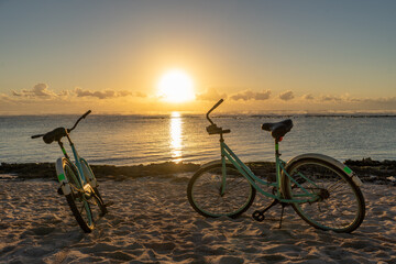Fototapeta premium Bicycles resting at dawn by the beach