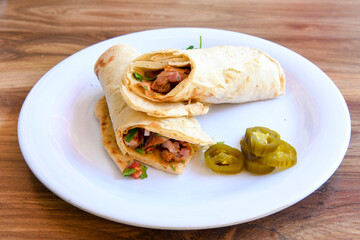 Lavash doner kebab ( zurna tavuk et doner durum )  or shawarma sliced in plate isolated. 
