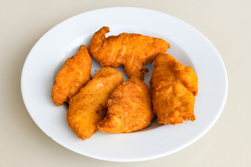 Fried Chicken breast hot crispy strips crunchy chicken tenders  isolated on white background.Nuggets isolated on white background on a plate