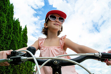 Naklejka premium Girl has damaged bicycle wheel and making repairs
