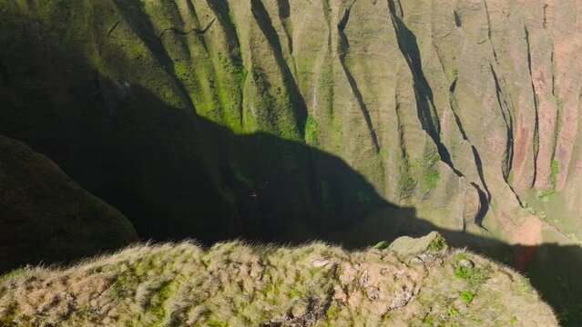 Kauai national park aerial 4K. Small helicopter flying in deep green mountain canyon, low above green jungle forest of Na Pali Coast National park. Sunny summer weather perfect for tourism flight USA