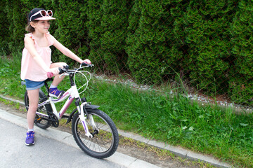 Fototapeta premium Girl has damaged bicycle wheel and making repairs