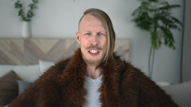 Portrait of funny crazy primitive man cave ancient in character of neanderthal, primitive person, Concept of history, modern and ancient combination, evolution having fun at home studio
