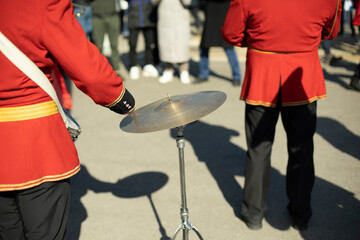 Drummer at parade in red clothes. Drumming.