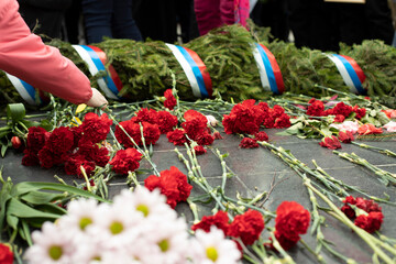 Flowers on grave of soldier in Russia. Details of funeral ceremony at Tomb of Unknown Soldier.