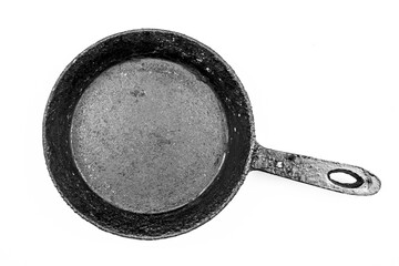 Old black frying pan with patina.Black frying pan on a white background. Cast iron pan isolated.