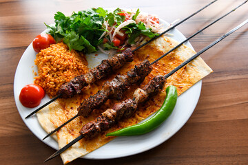 Beef steak grill with rice pilaf, fried potatoes, grilled pepper and tomatoes.Mix Platter with Beef rips, Cutlets, Potatoes and Sauces.