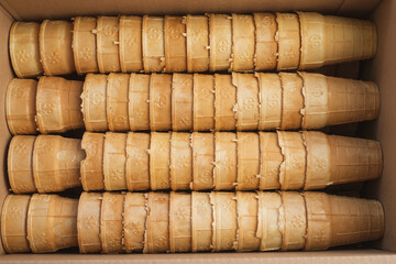 Opened cardboard box of empty flavorful ice-cream cones. Ready to be filled with ice cream.