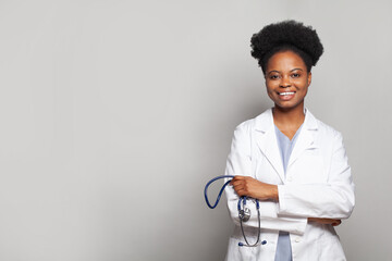 Portrait of happy medical intern doctor standing on white background