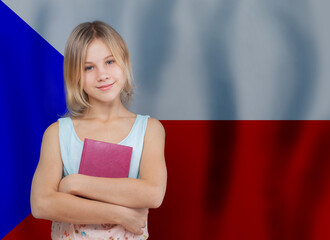 Pretty young blonde teen girl with book against Czech flag background. Education and school in...