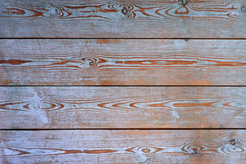 A natural, textured background of old horizontal wooden boards with scuffed blue, brown paint.