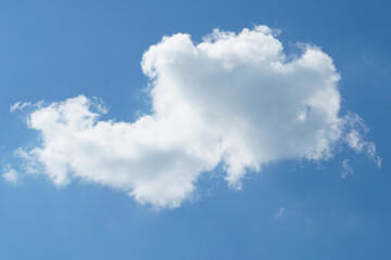 lonely cloud against the blue sky on a sunny day