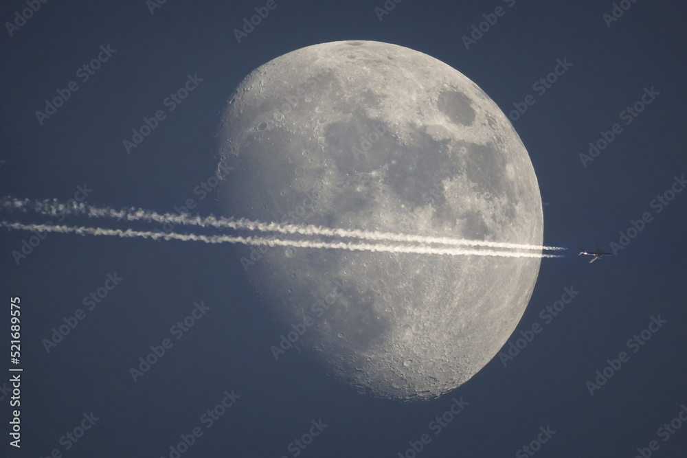 Wall mural an airplane flying in front of the moon
