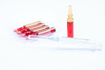 Injection of vitamins B 12. Ampoules with red liquid. Copy space