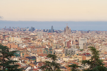 Views of the city of Barcelona at sunset with the emblematic Sagrada Familia and the Agbar Tower in...