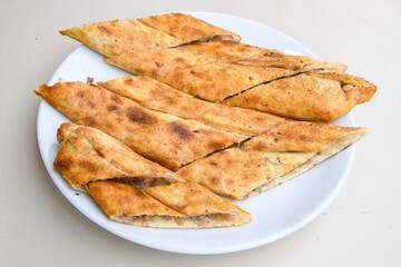 Pide, karisik pide, mixed pita. Turkish pide with sucuk sausage, meat and cheese. Turkish pizza. mixed pita. Pide on white background. 