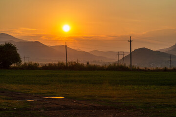Obraz premium Fabulous sunset landscape with field and mountains, Armenia