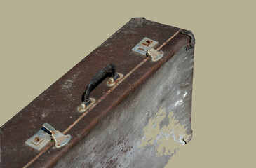 Old discarded suitcase on a beige background.