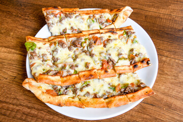 Pide, karisik pide, mixed pita. Turkish pide with sucuk sausage, meat and cheese. Turkish pizza. mixed pita. Pide on white background. 