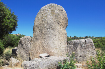 Arched stele seen from behind in the nuragic-era archaeological site of Giants' grave of S'Ena'e Thomes, Sardinia, Italy
