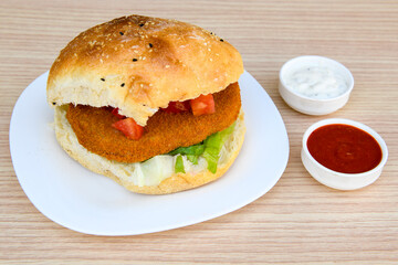 Big tasty burger with beef cutlet on a plate. Crispy chicken burger.