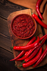 Red, Hot sauce, chili pepper, on a wooden table, no people, vertical, top view,