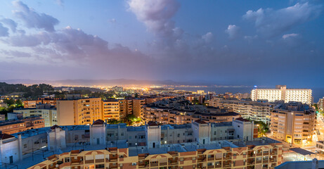 Panorama aerial view of Torremolinos cityscape at dusk and Malaga bay in Costa del Sol, Spain