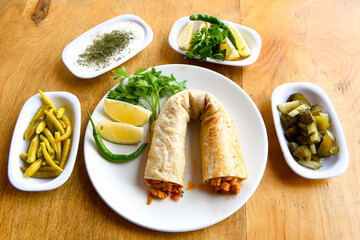 Meat, chicken shawarma kebab with yogurt and fried butter sauce .Tantuni Special. Yogurtlu et , tavuk tantuni.