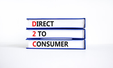 D2C direct to consumer symbol. Concept words D2C direct to consumer on books on a beautiful white table white background. Business and D2C direct to consumer concept. Copy space.